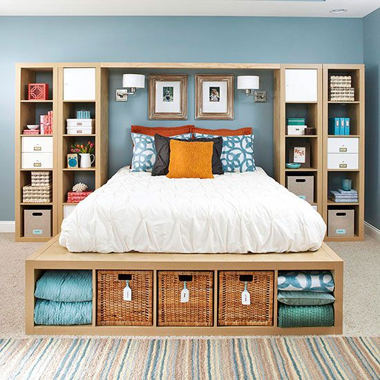 A platform bed with storage built into the frame and cubbies built around the bed for storage.