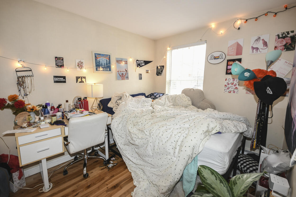 A very cluttered bedroom needing some additional storage.