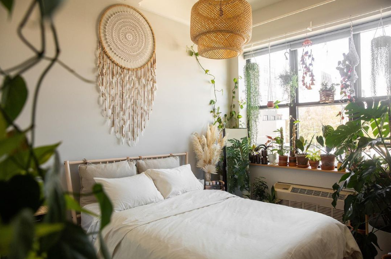 a bedroom with a bed and plants