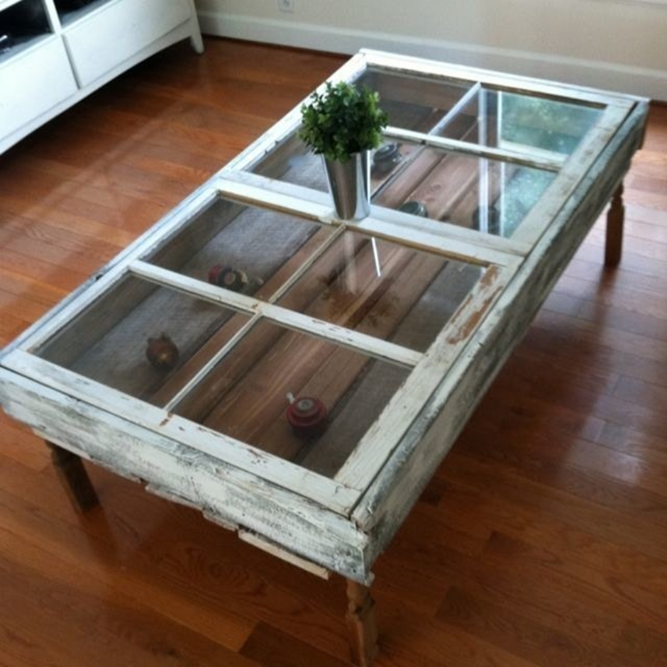 Antique window frame transformed into a rustic coffee table with glass top.