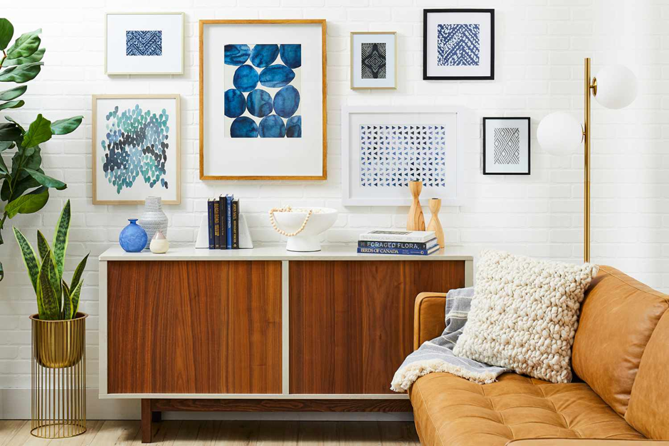 Neutral-toned gallery wall with botanical prints and wooden accents