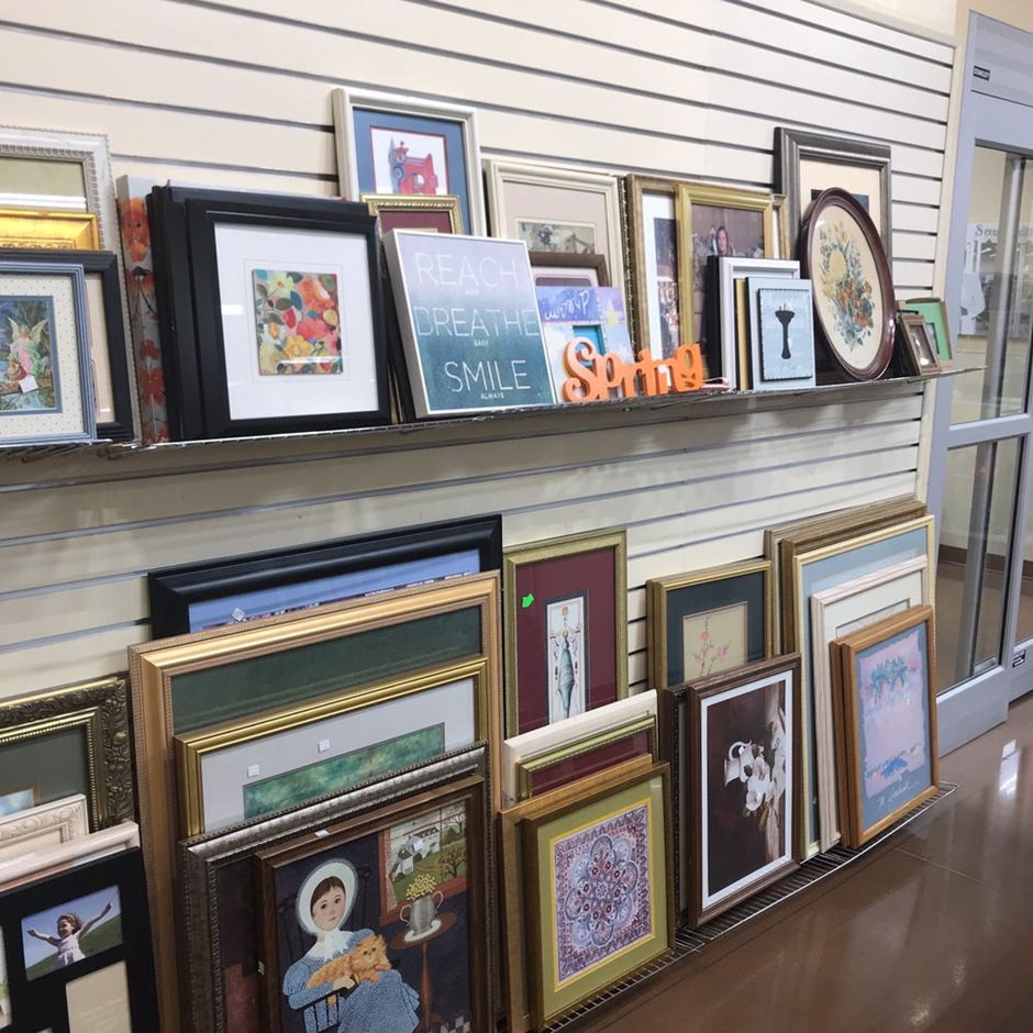 Affordable gallery wall featuring personal photos and mismatched frames