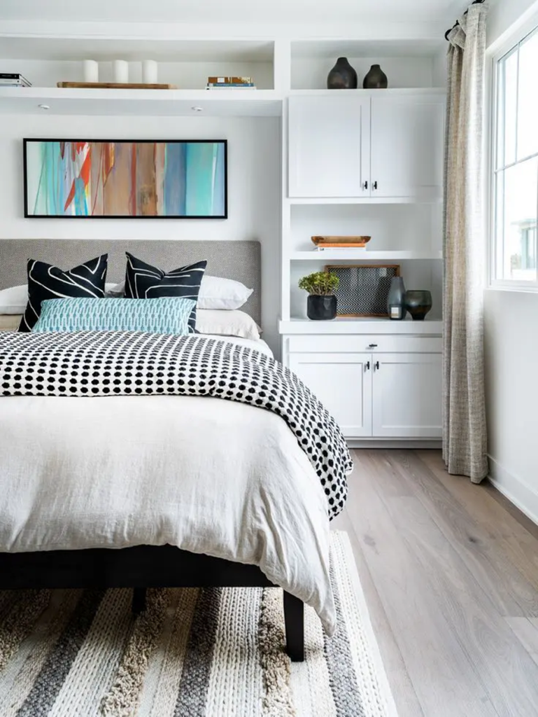 Modern bedroom with built-in white shelving and decorative accents
