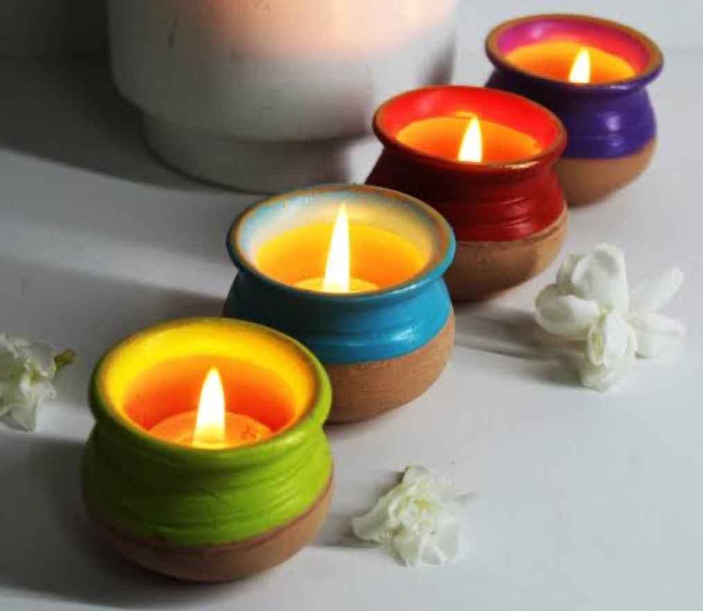 Hand-painted flower pots repurposed as Candle Holders