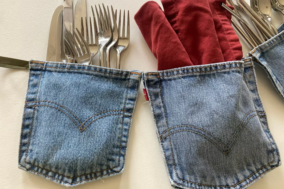 two jeans pockets being used as silverware holders.