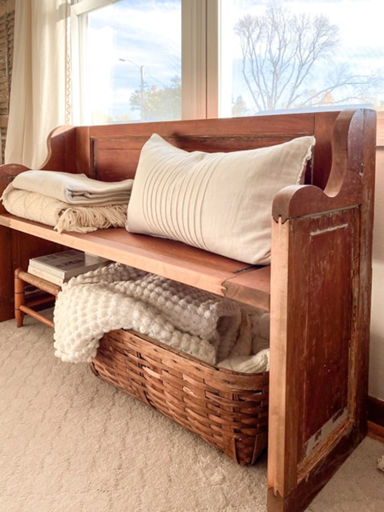 Wooden bench with pillows and blanket storage
