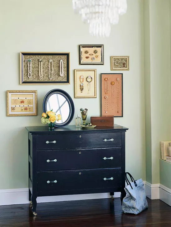 Creative frames above a dresser in a colorful room.