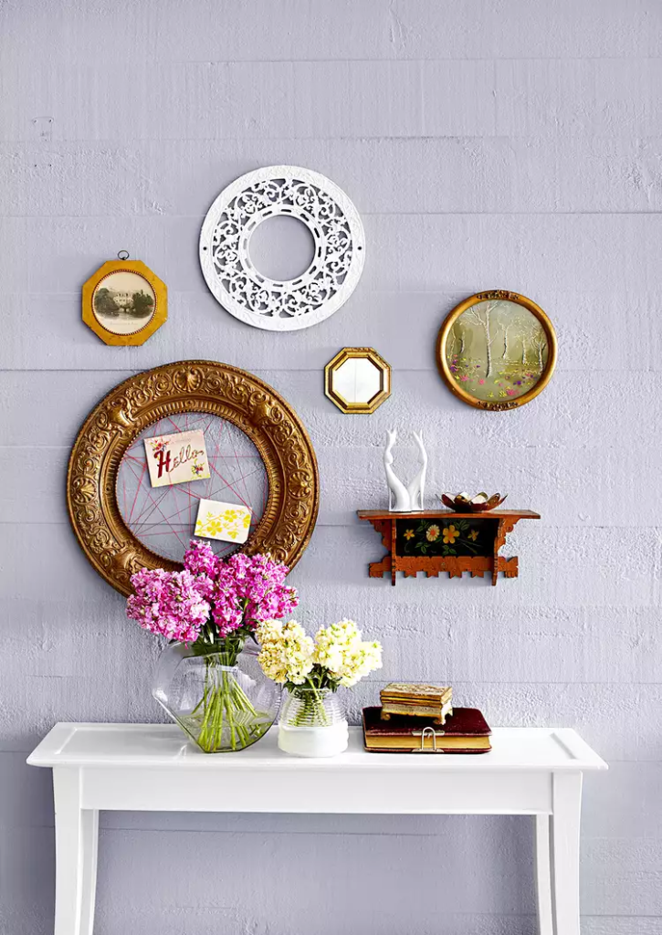 AN entryway mantle made unique with different frames.