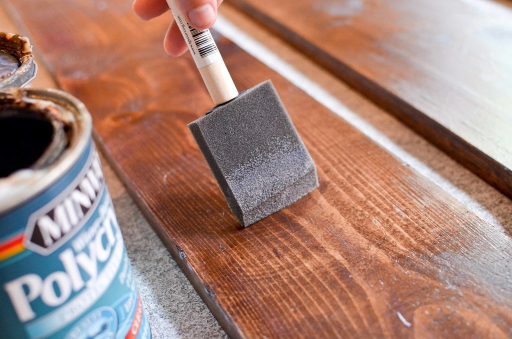 Applying wood stain with sponge brush