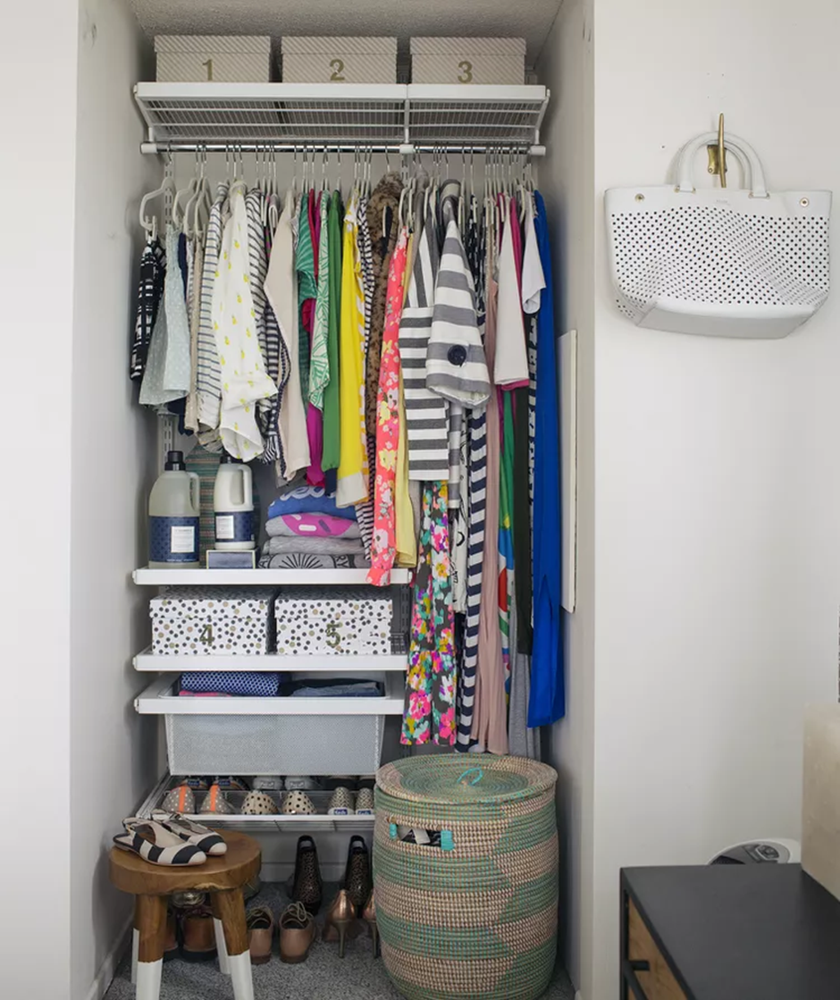 Small organized closet with colorful clothes, labeled bins, and storage baskets