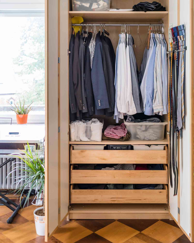 Men’s wardrobe with shirts, suits, and wooden drawers for folded clothes