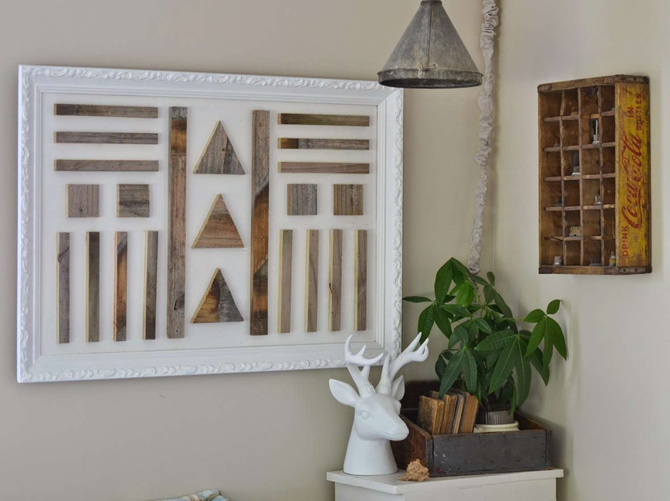 Rustic geometric wood wall art framed in white with indoor plant décor