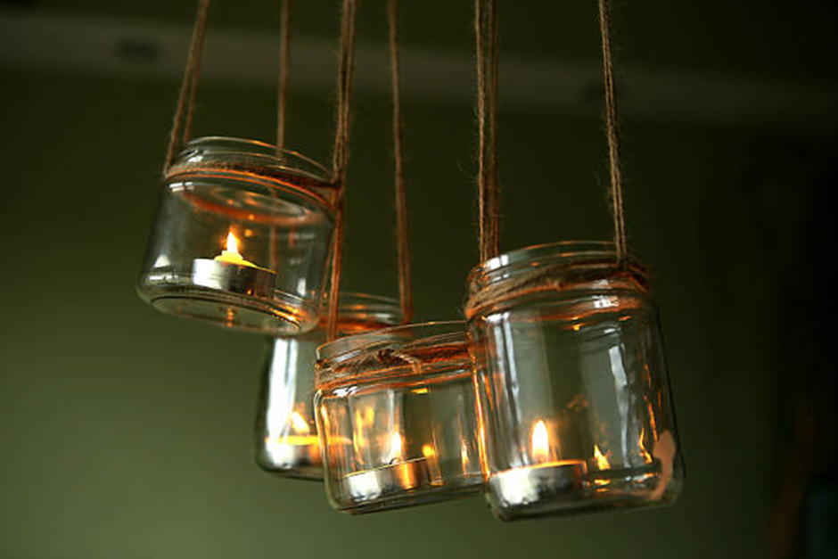 hanging mason jar candle lanterns glowing with tealight candles
