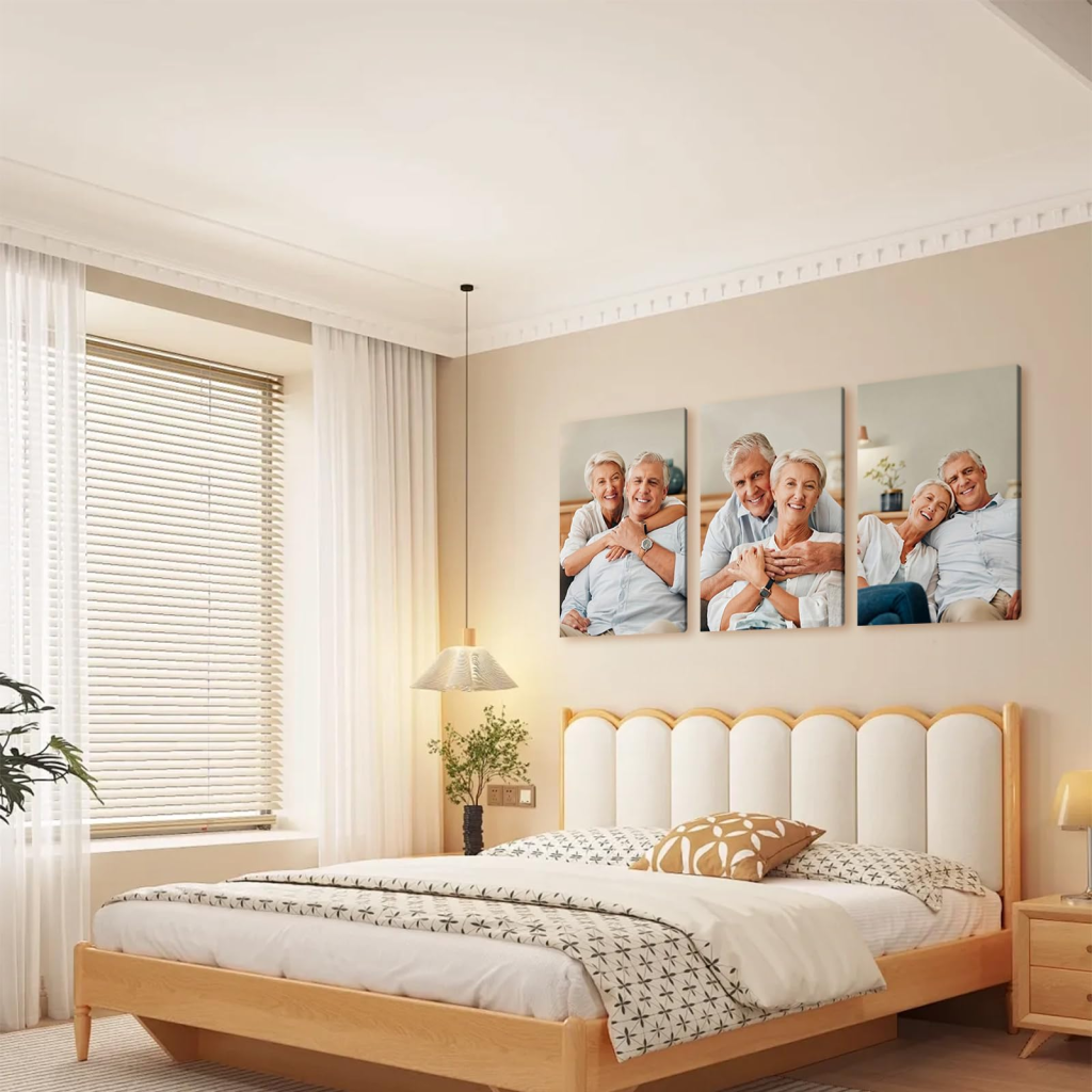 Cozy modern bedroom with light wood bed frame, soft neutral bedding, sheer curtains, and three-panel family photo wall art above the headboard