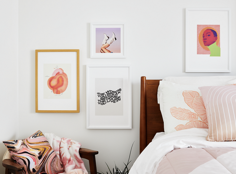 A bedroom with a focus on the art on the wall.