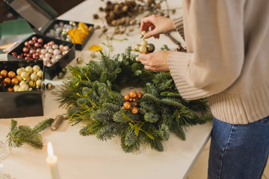 Making a budget-friendly seasonal wreath using simple holiday craft supplies