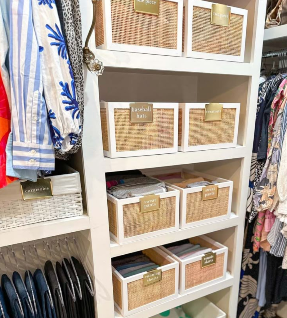 Closet shelving with labeled baskets organizing hats, sweatpants, skirts, and casual clothing