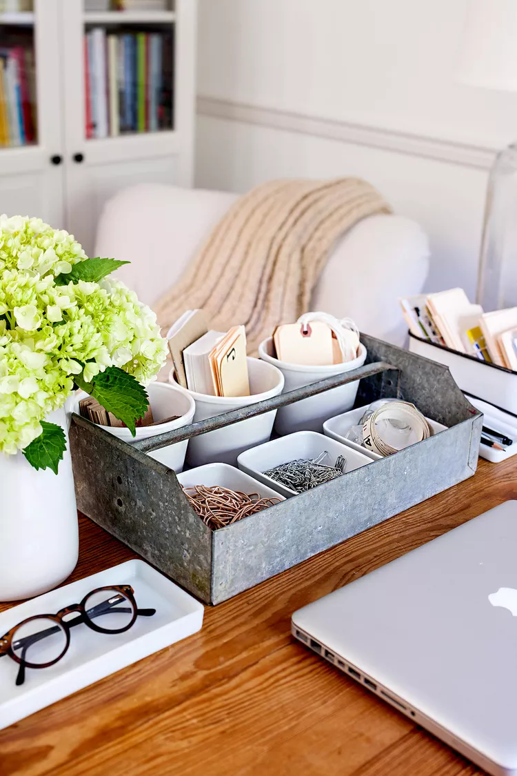 Organized home office desk with metal storage tray, stationery, laptop, and minimalist decor