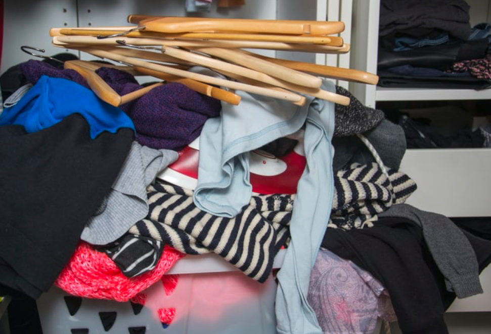 Messy closet with tangled clothes and hangers showing the need for wardrobe decluttering and organization