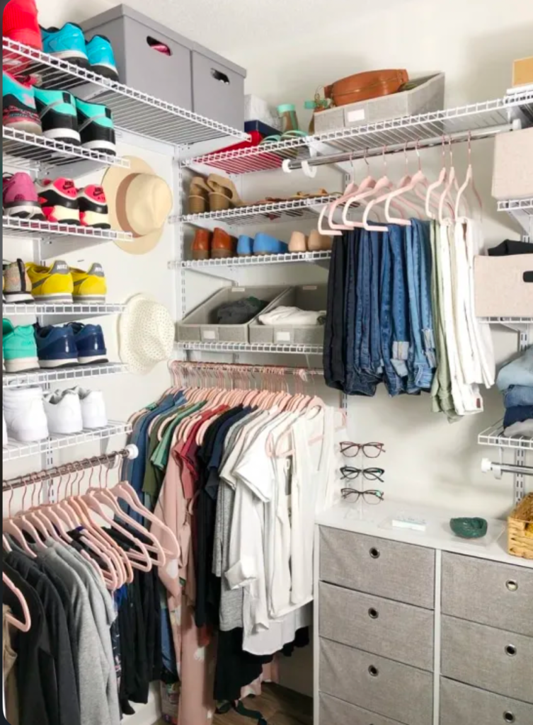 Modern closet system with wire shelves, shoe storage, folded jeans, hanging tops, and labeled storage bins