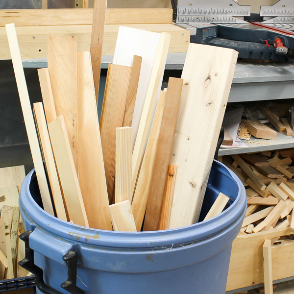 Bucket filled with reclaimed wood planks and scrap lumber for DIY shelving projects