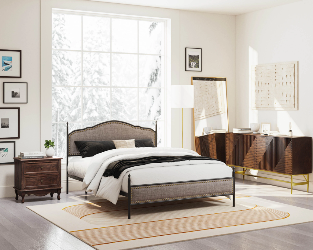 Bright modern bedroom with large window, upholstered bed frame, wooden dresser, and neutral color palette