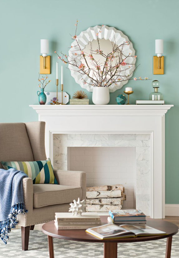 a fireplace with a mirror and a vase on top