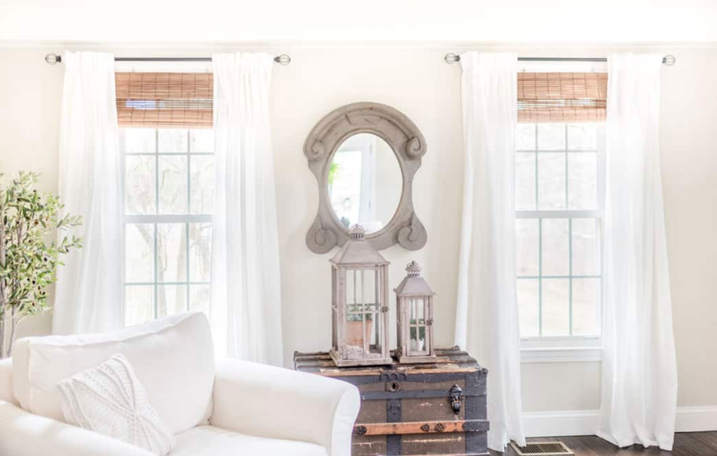 Sloped ceiling bedroom with striped curtain panel covering skylight window