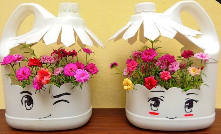 Modern blue wooden planter box with decorative cutout design holding lush green fern plants