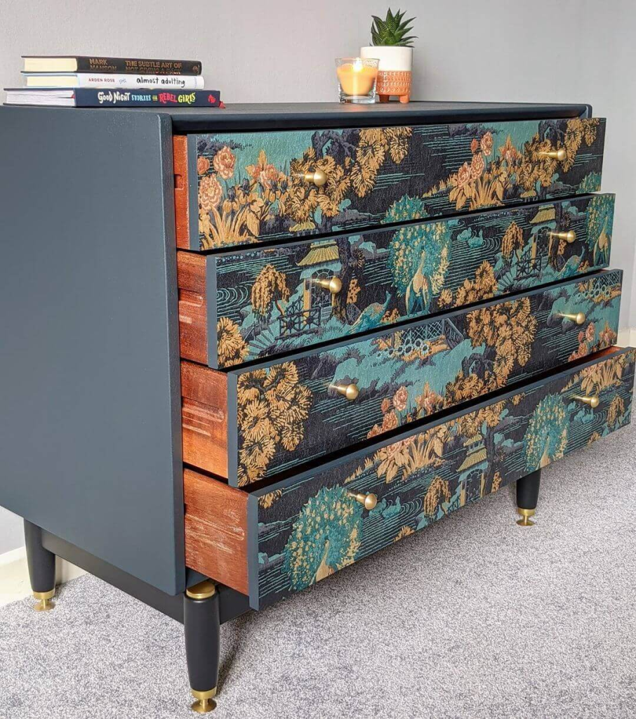 Upcycled dresser makeover with patterned wallpaper drawer fronts and brass knobs
