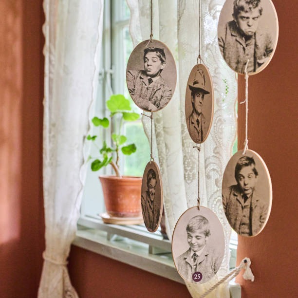 Creative hanging photo display using vintage portrait prints and string for DIY wall décor