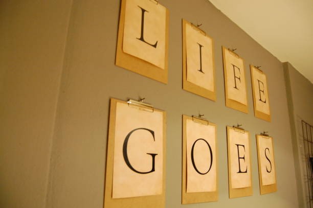 Minimalist wall décor displaying framed letters spelling “Life Goes” in neutral tones