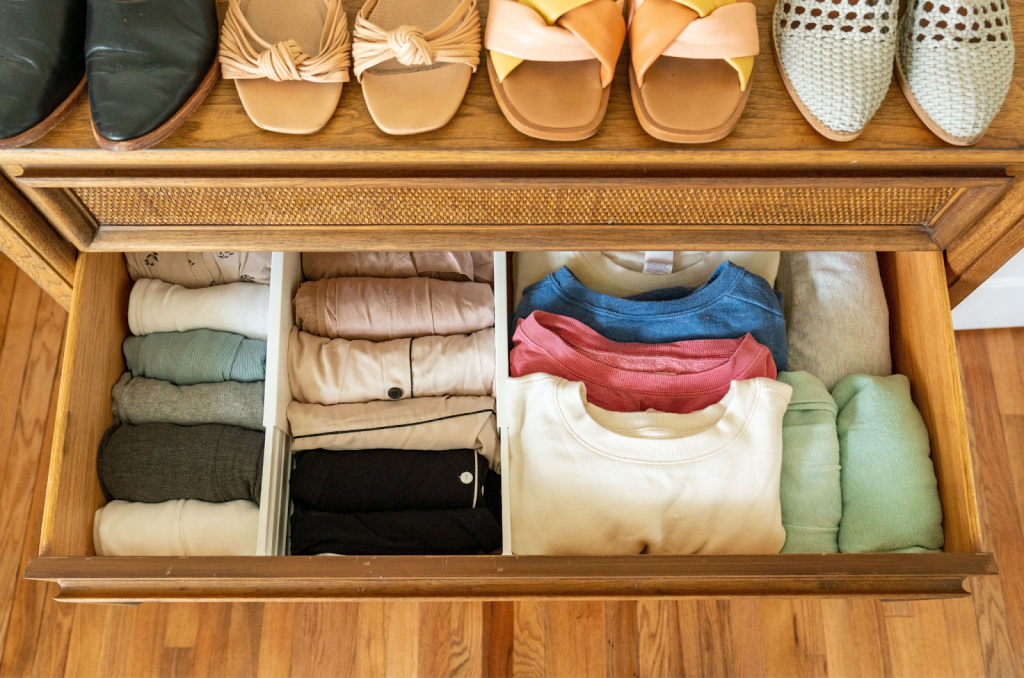 Organized drawer with folded shirts and neatly arranged shoes for efficient closet storage
