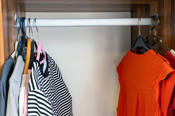 Clothes hanging on a closet rod showing everyday wardrobe organization and storage space