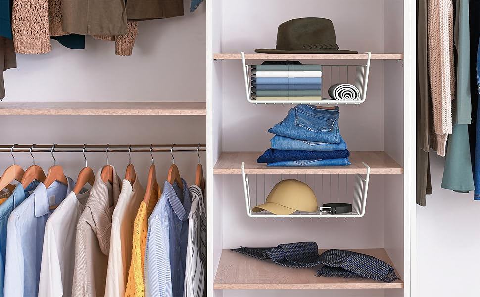 Organized closet with hanging shirts and wire shelf baskets storing folded jeans, hats, and accessories