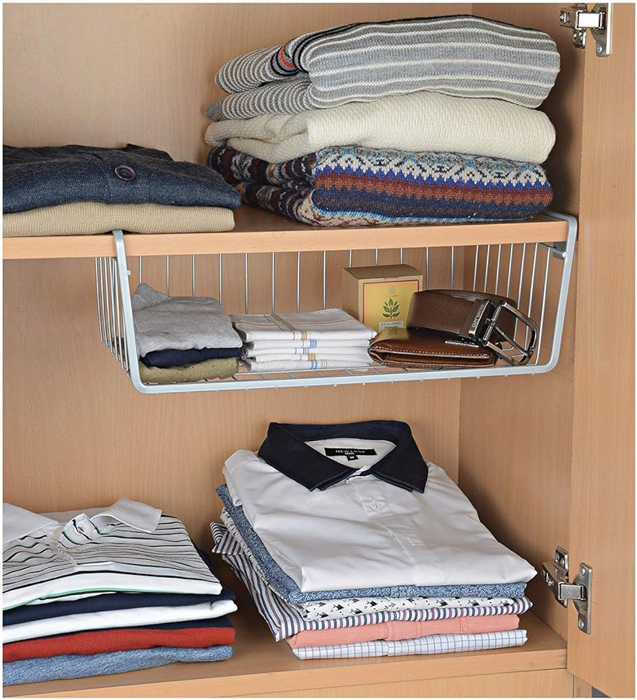 Closet shelf with folded sweaters, shirts, and wire under shelf basket for space saving storage