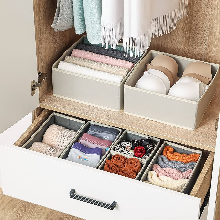 Closet drawer storage boxes organizing folded towels, bras, socks, and accessories in a modern wardrobe cabinet
