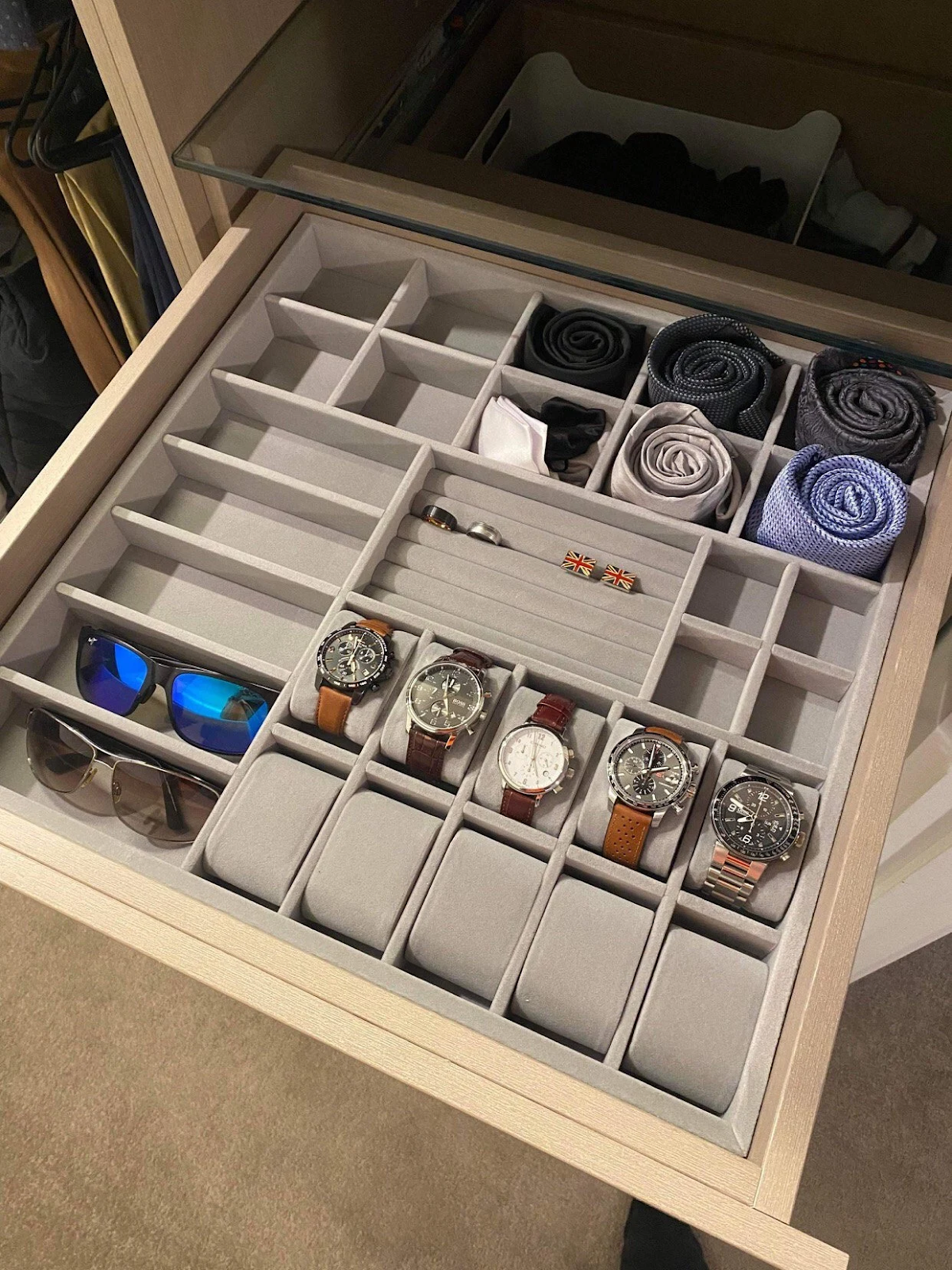 Drawer organizer with watches, sunglasses, ties, cufflinks, and jewelry neatly arranged in felt compartments