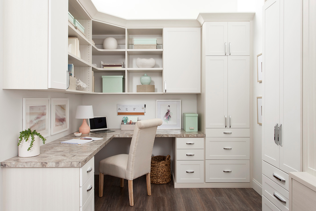 Built-in home office and closet storage system with desk, cabinets, and organized shelving