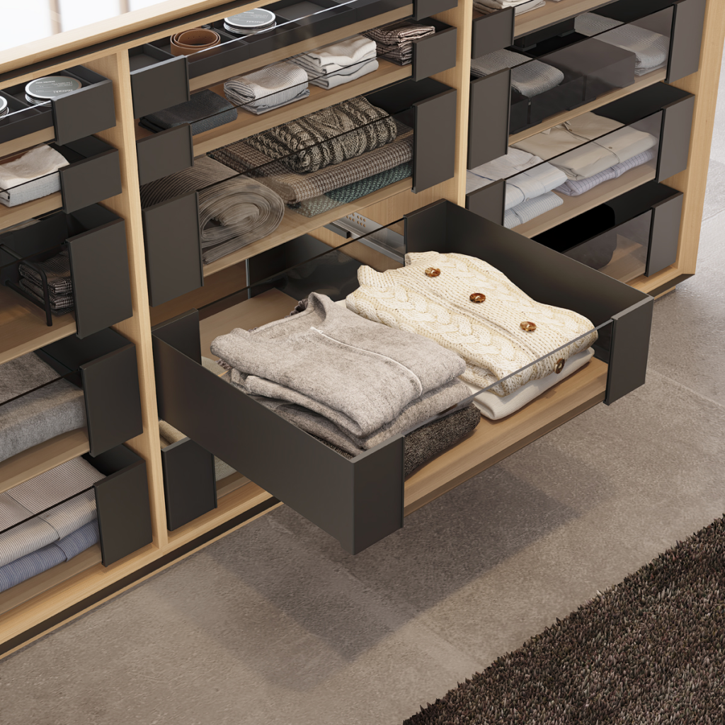 Closet drawer organization with neatly folded sweaters and modular storage compartments