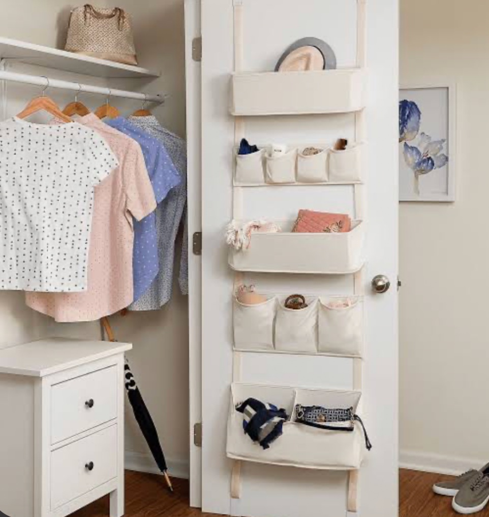 Over-the-door fabric organizer used for closet storage with clothes and accessories
