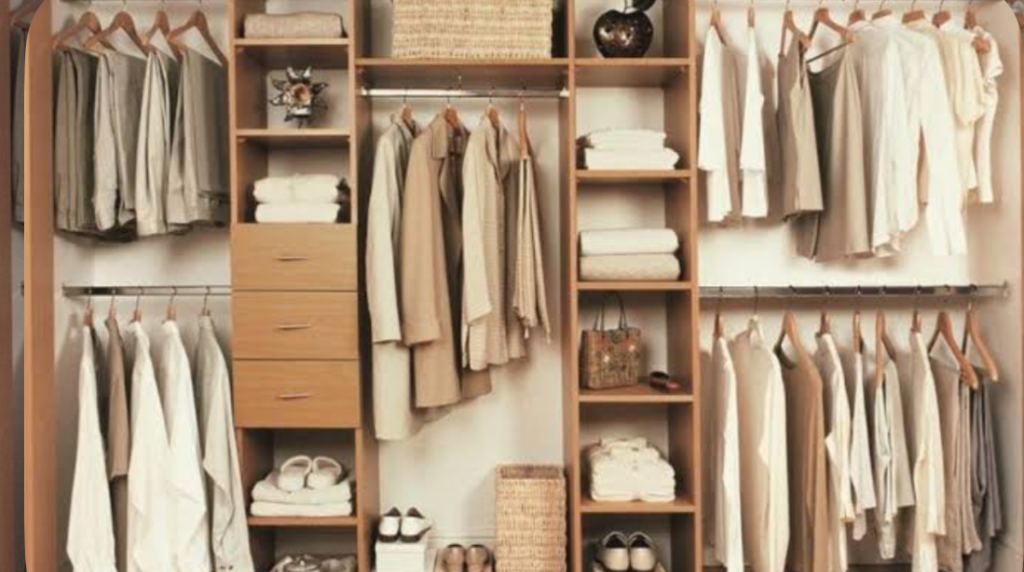 Built-in wooden closet system with shelves, drawers, and neatly arranged hanging clothes