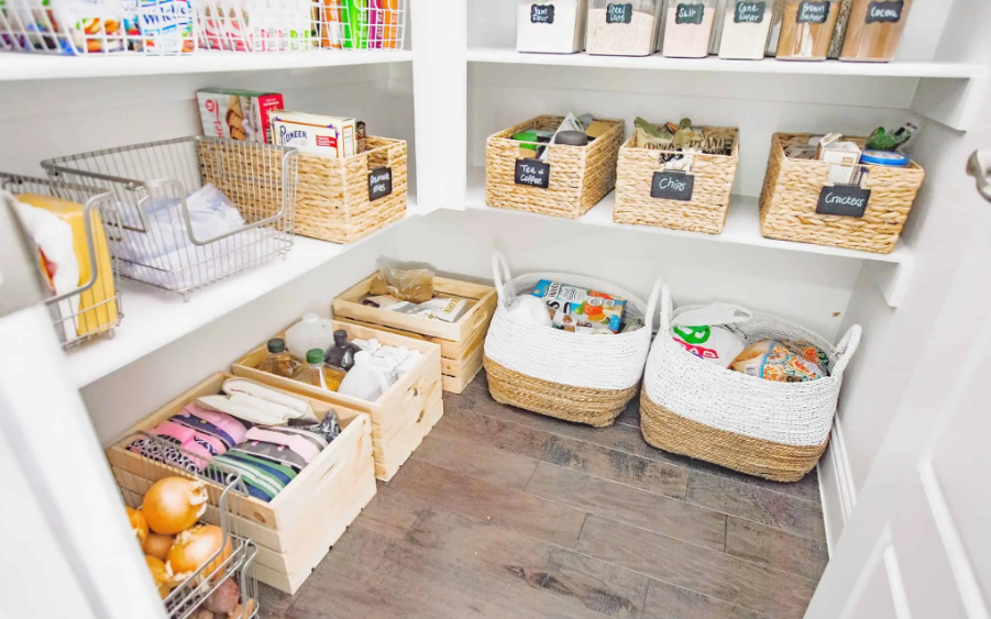 Cluttered pantry shelves filled with groceries, canned food, and dry goods before kitchen organization