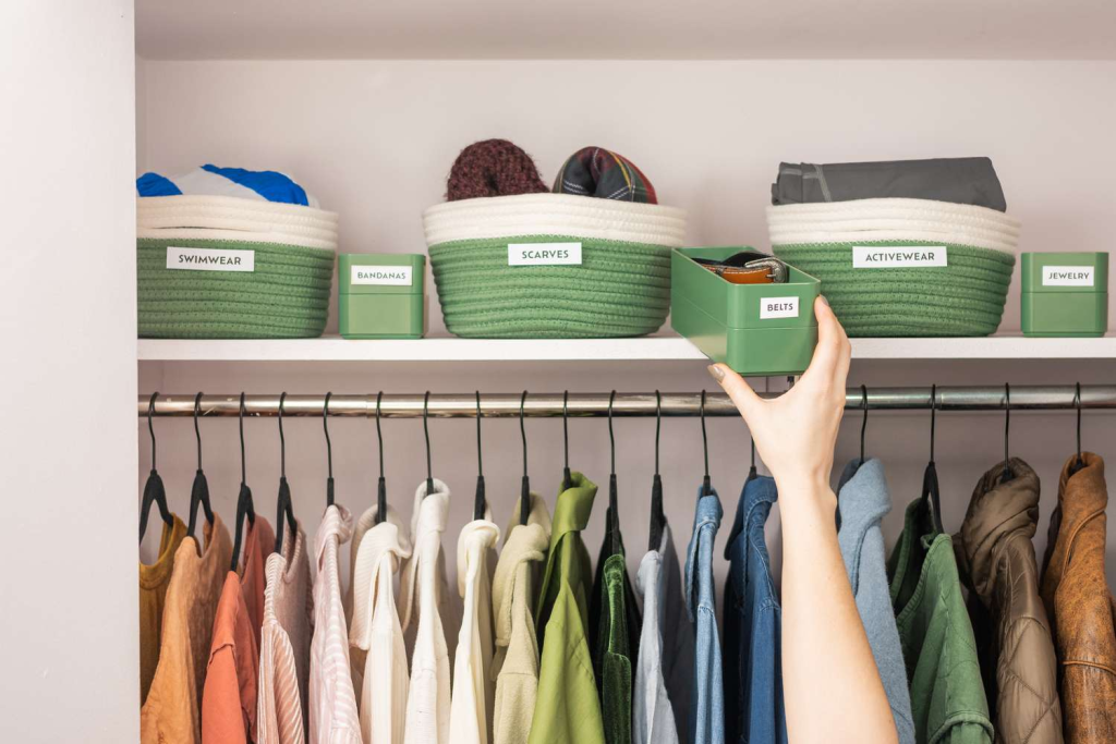 Organized closet with labeled storage bins for scarves, belts, activewear, and accessories