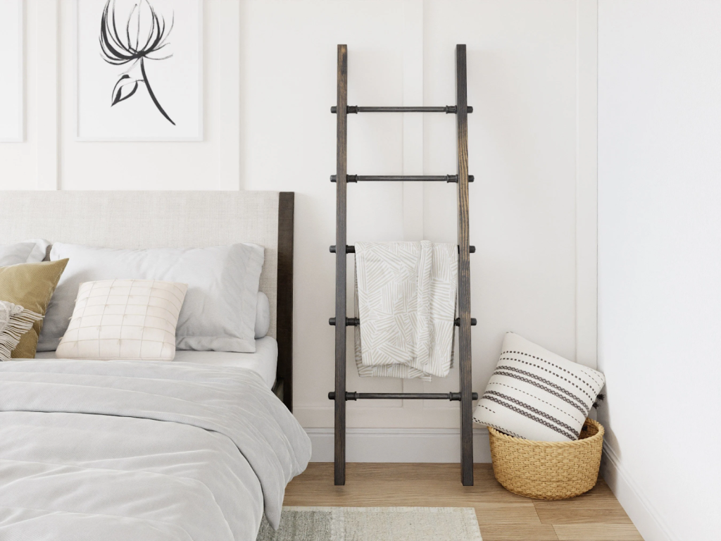 Minimalist bedroom with decorative ladder shelf used for stylish blanket storage