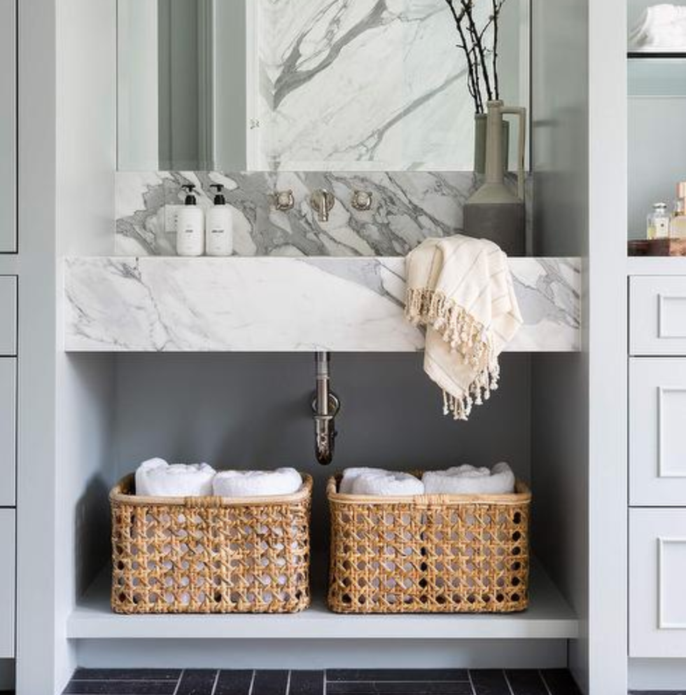 organized bathroom vanity with sink tray and skincare storage display