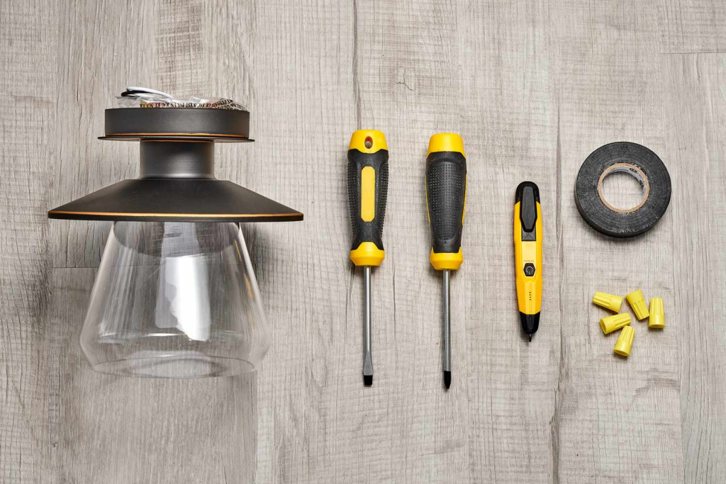 DIY pendant light kit with lamp shade electrical tester screwdrivers and wiring supplies