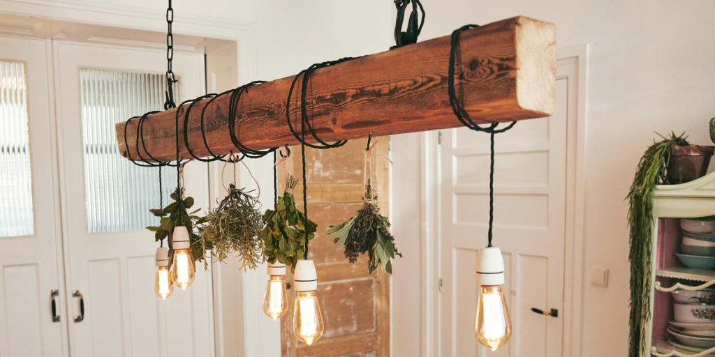 rustic DIY wooden beam light fixture with hanging Edison bulbs and dried herbs