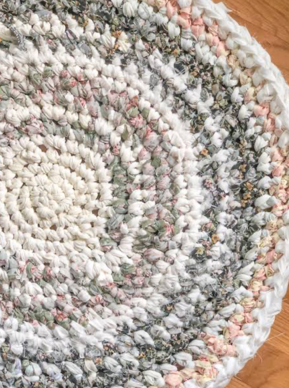 close up of handmade braided rag rug with soft fabric strips and textured circular pattern