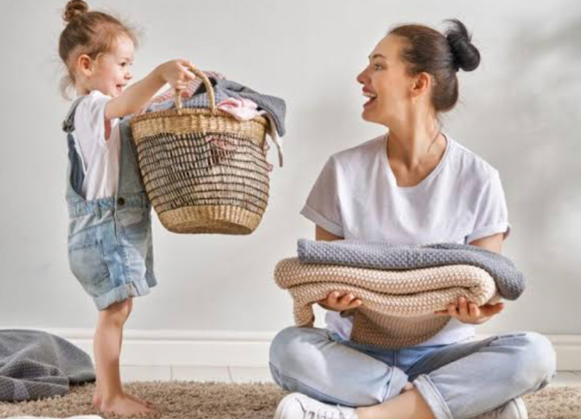 mother and child organizing blankets and laundry during a family decluttering session